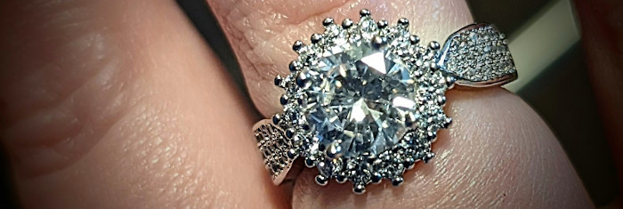 white gold and clear stones; the word starburst comes to mind, with hints of snowflake; hard to describe, but very pretty