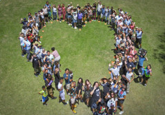 aerial view of lots of people standing in the shape of a heart